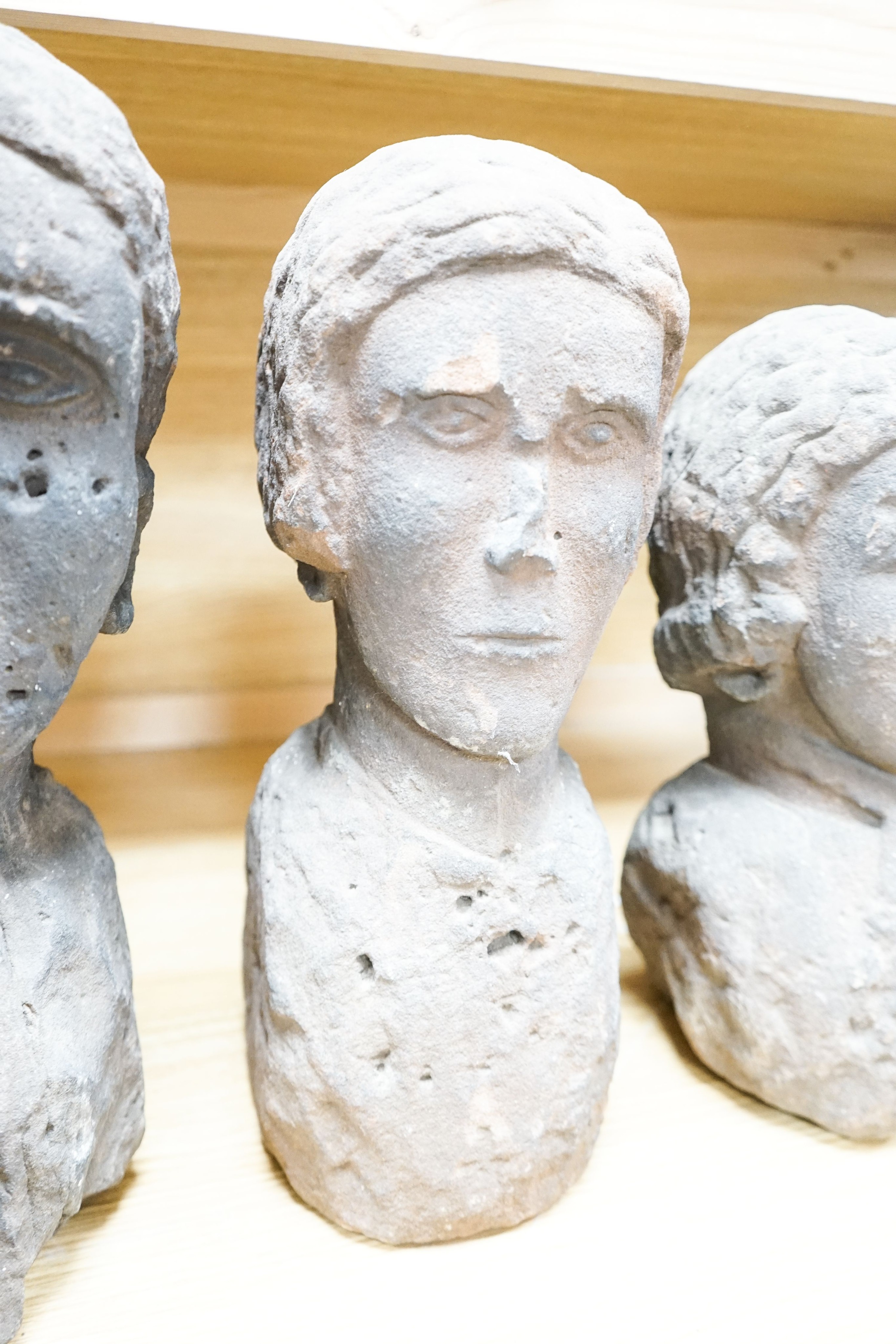 Three red sandstone busts of two ladies and a gentleman, 41cm